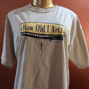 A Beige T-shirt Bye Gildan Size L Proof God Has A Sense Of Humor